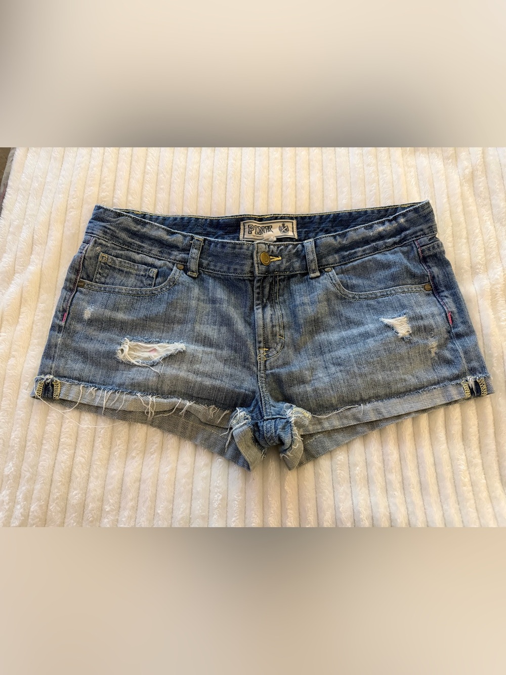 Victoria’s Secret Pink Low-rise denim shorts featuring a destructed wash